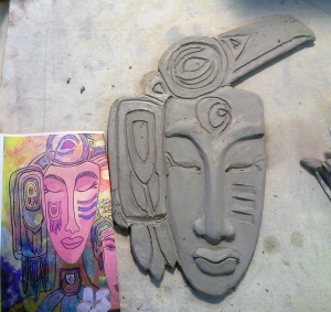 today's mask with a print copy of "Raven Knows It's Time to Wake."  The symbol on the forehead of the clay mask is the symbol that came to me as mine at Life is a Verb Camp, under the guidance of Mary Anne Radmacher.