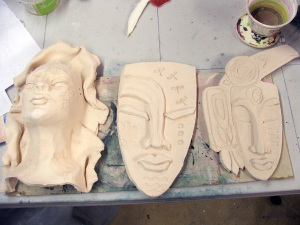3 masks by Tammy Vitale, bisque-fired for raku.  the middle will go into the fire 11/22 and we'll see about the others after that.
